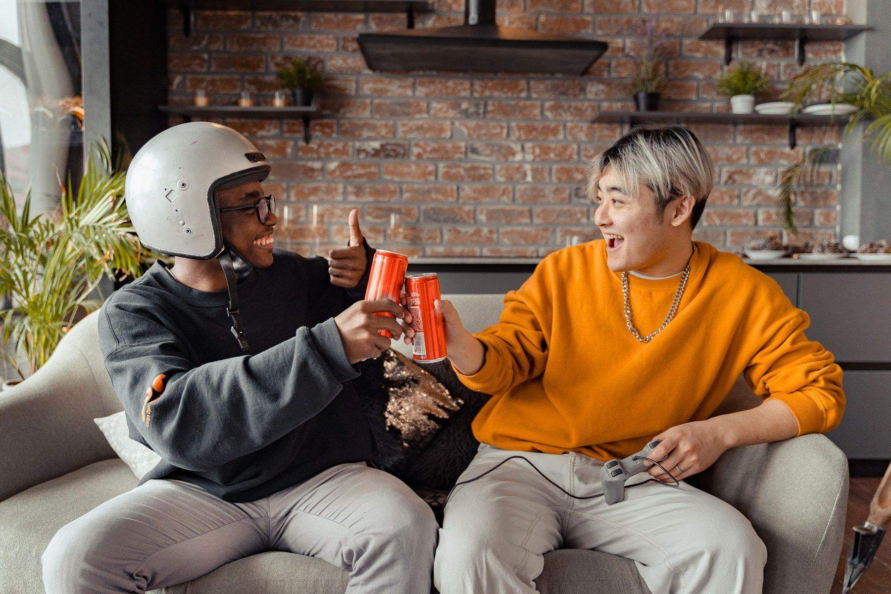 Two colleagues sitting together on a break with cold drinks