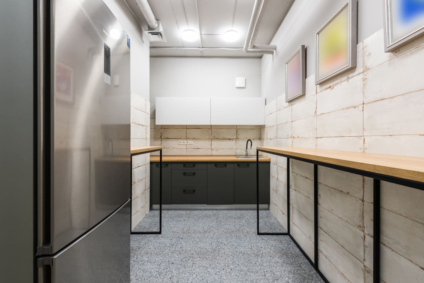 A modern break room with a wooden counter and natural light